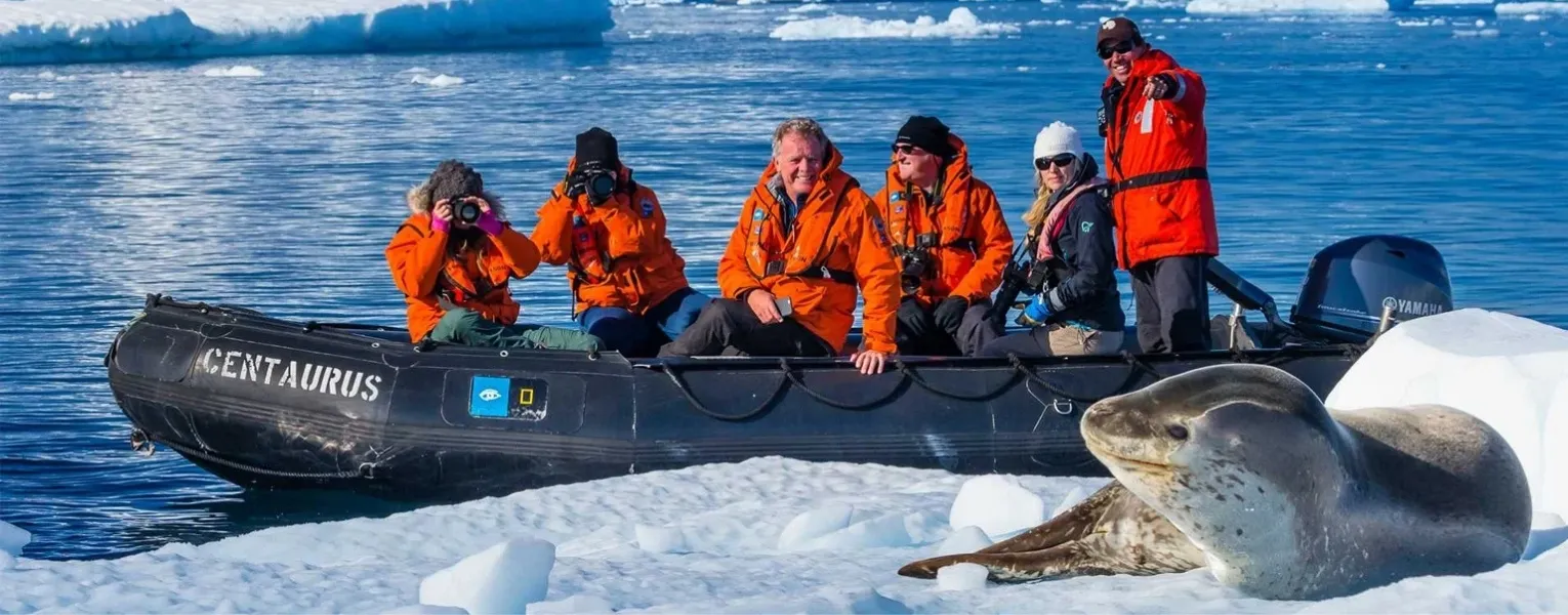Antarctica Tour Packages expedition ship and penguins